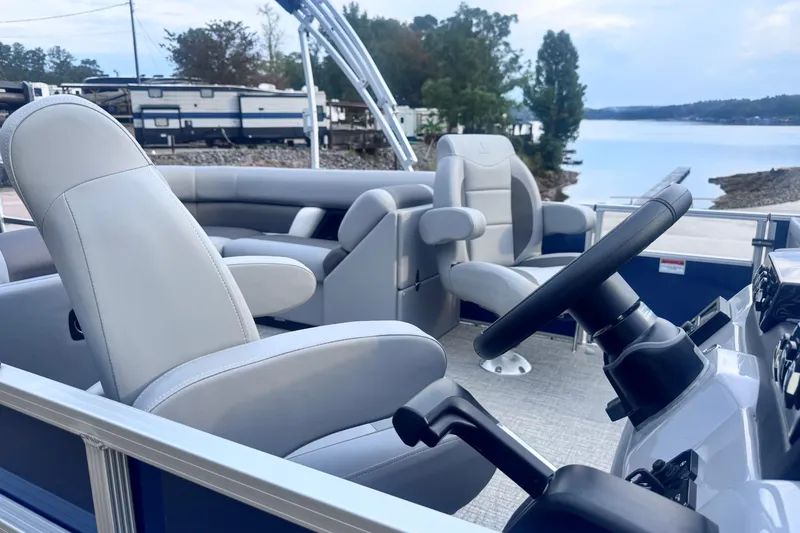 Slide: The Image of 2026 Landau ISLAND BREEZE 21 pontoon boat interior with plush seating and steering wheel. - 12