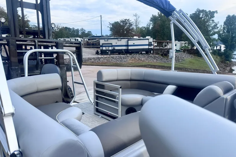 Slide: The Image of 2026 Landau ISLAND BREEZE 21 pontoon boat interior with gray seating and outdoor setting. - 13