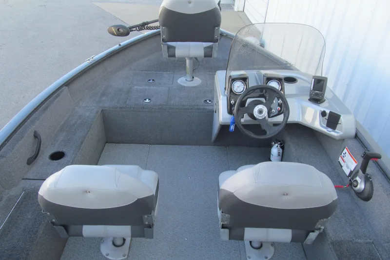 Slide: The Image of 2016 Tracker Pro Guide V-16 SC boat interior with steering console and seating. - 4
