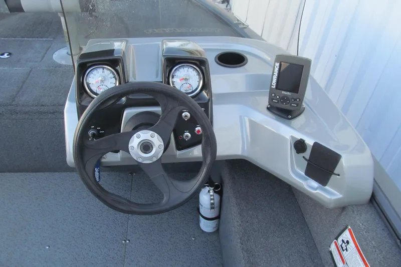 Slide: The Image of 2016 Tracker Pro Guide V-16 SC boat dashboard with steering wheel and gauges. - 5