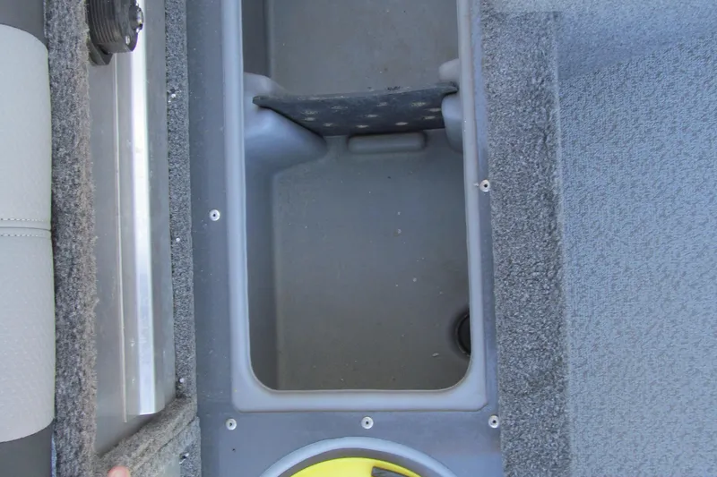 Slide: The Image of 2016 Tracker Pro Guide V-16 SC battery compartment with charger and battery. - 8