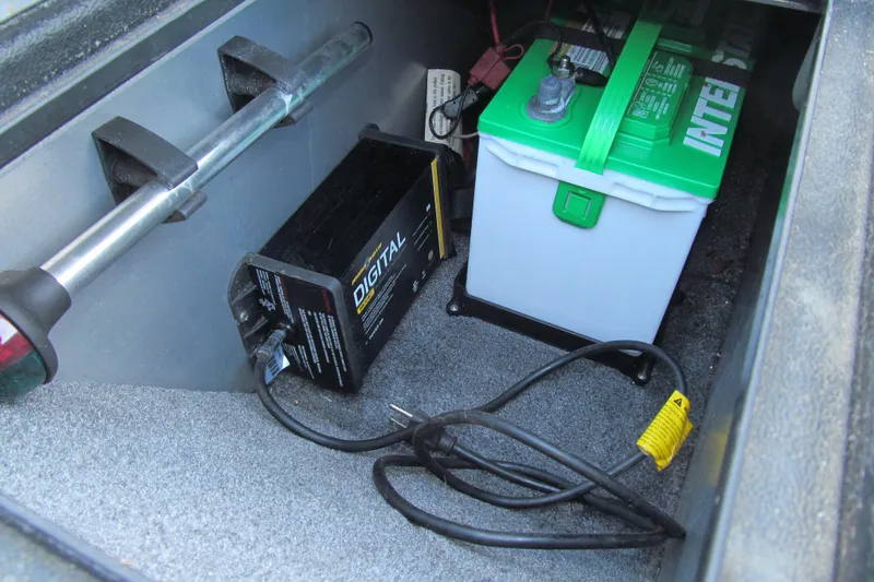 Slide: The Image of 2016 Tracker Pro Guide V-16 SC boat storage compartment with yellow lid and open space. - 9