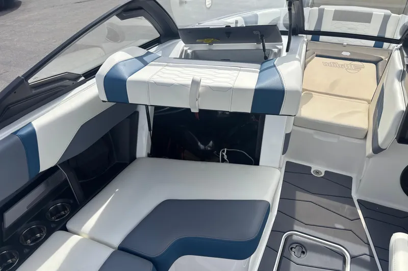 Slide: The Image of 2025 Malibu Wakesetter 22 MXZ interior with blue and white seating, showcasing modern design. - 13