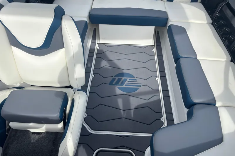 Slide: The Image of 2025 Malibu Wakesetter 22 MXZ interior with blue and white seating. - 14