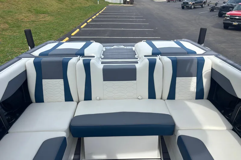 Slide: The Image of 2025 Malibu Wakesetter 22 MXZ interior with stylish blue and white seating. - 15