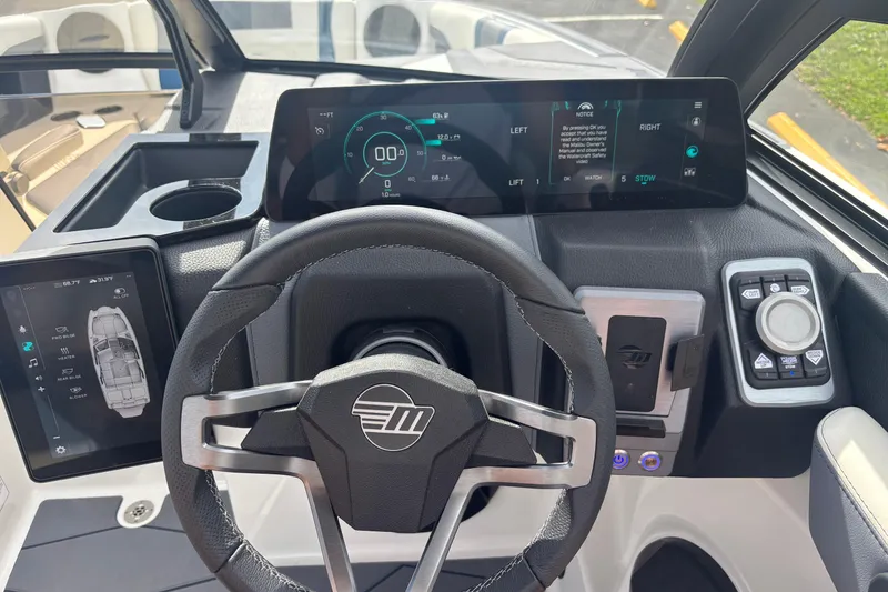 Slide: The Image of 2025 Malibu Wakesetter 22 MXZ dashboard with advanced digital controls and steering wheel. - 3