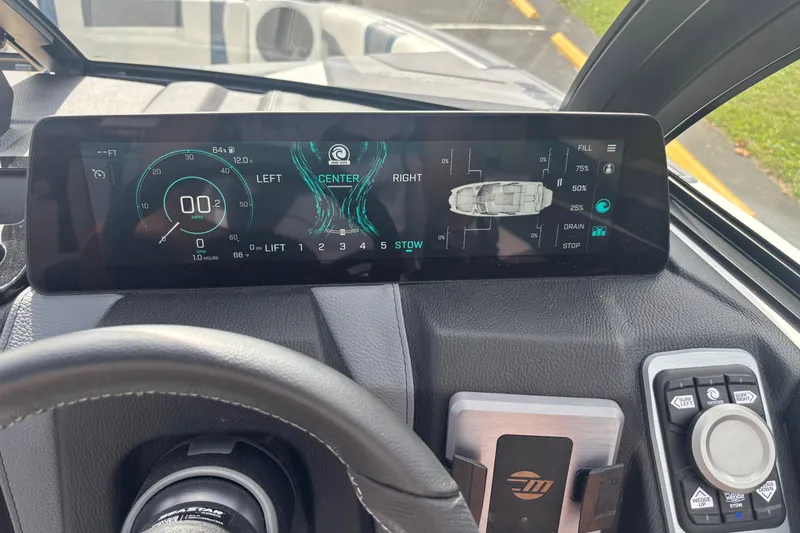 Slide: The Image of Dashboard of 2025 Malibu Wakesetter 22 MXZ with digital display and controls. - 4