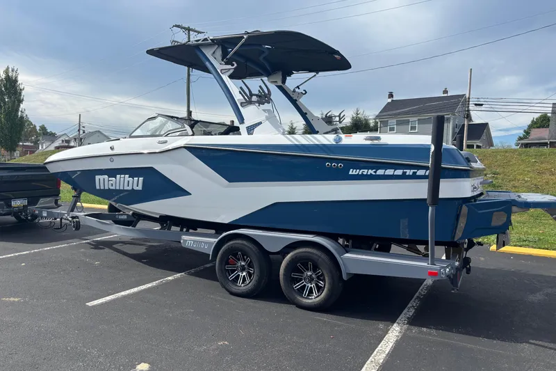 Slide: The Image of 2025 Malibu Wakesetter 22 MXZ boat on trailer in parking lot. - 6