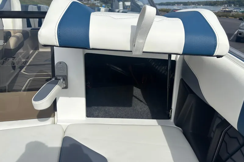 Slide: The Image of 2025 Malibu Wakesetter 22 MXZ interior seating with storage compartment open. - 9