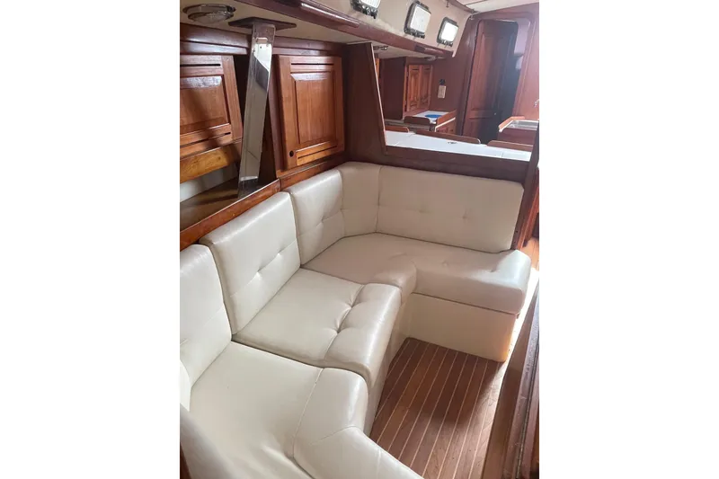 Slide: The Image of Luxurious interior of 2002 Tartan 37 yacht with white leather seating and wooden cabinetry. - 12