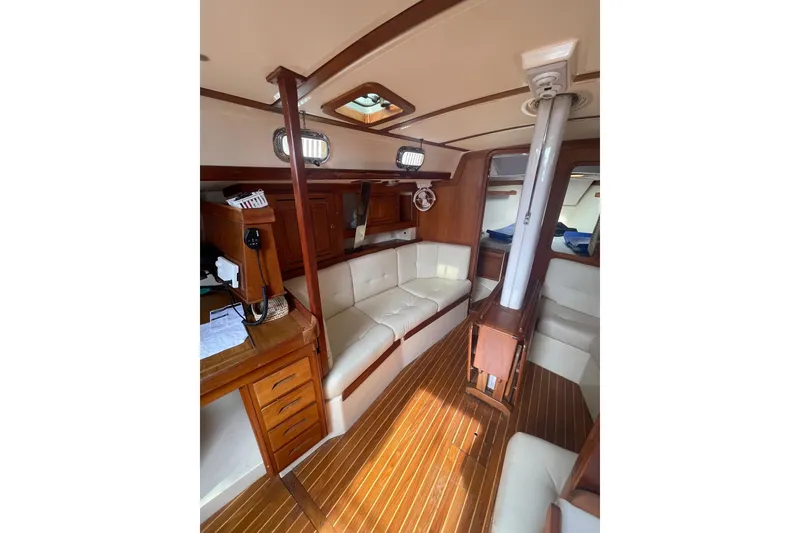 Slide: The Image of Interior of 2002 Tartan 37 sailboat with wood accents and white seating. - 13