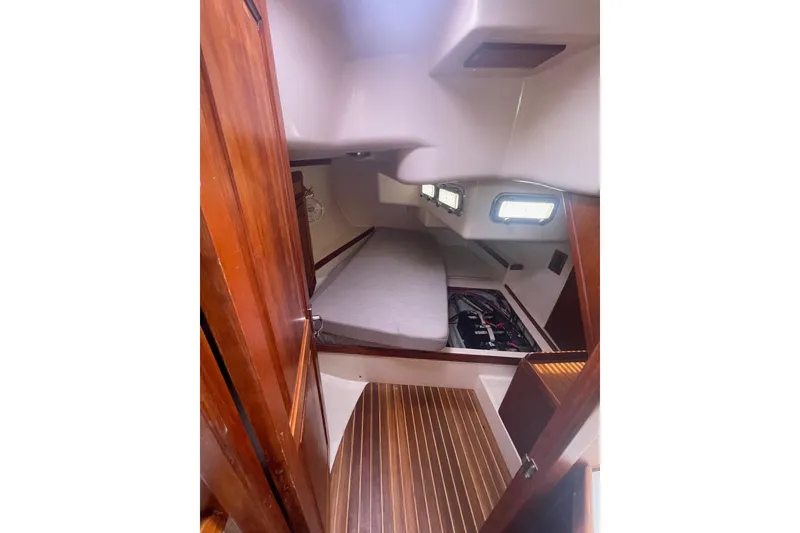 Slide: The Image of Interior cabin of 2002 Tartan 37 sailboat with wooden flooring and cozy sleeping area. - 16