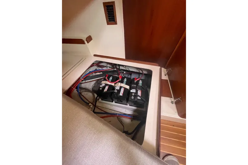 Slide: The Image of Battery compartment of a 2002 Tartan 37 sailboat, showing wiring and connections. - 17