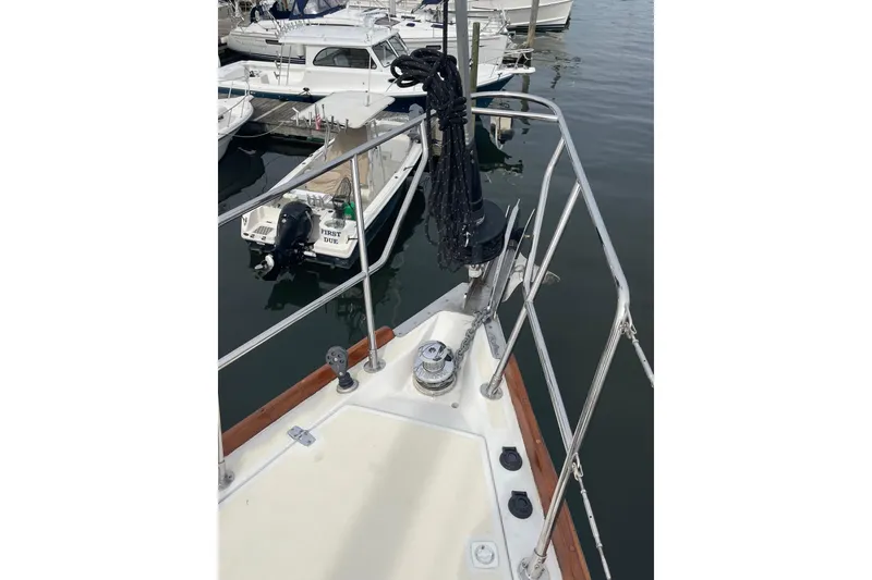 Slide: The Image of Bow of 2002 Tartan 37 sailboat docked, featuring railing and winch. - 4