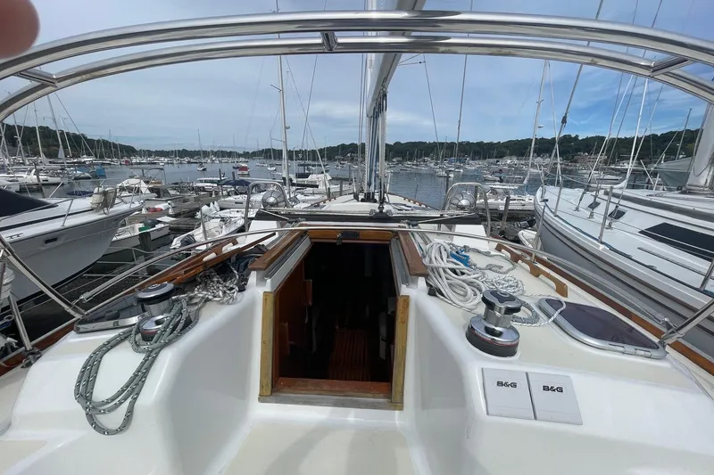 Slide: The Image of Cockpit view of a 2002 Tartan 37 sailboat docked in a marina. - 6