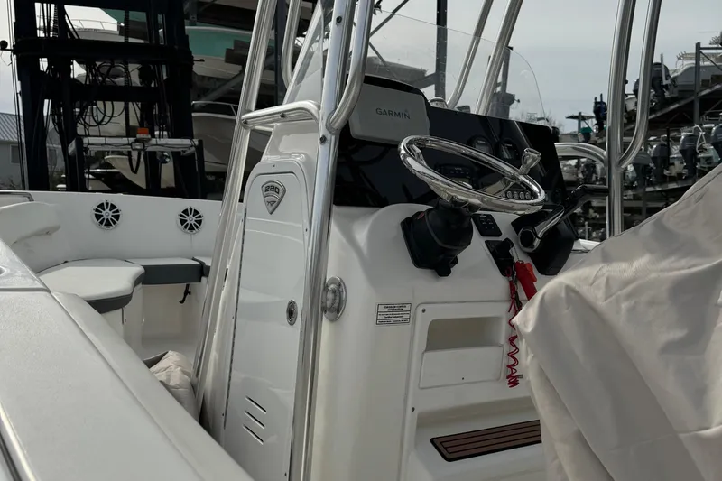 Slide: The Image of 2017 Tidewater 220 CC Adventure boat interior with steering console and seating. - 10