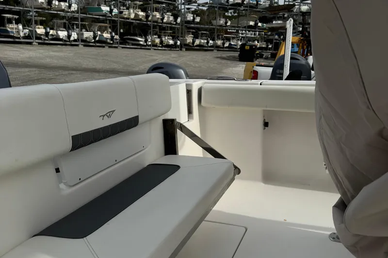 Slide: The Image of 2017 Tidewater 220 CC Adventure boat interior with seating and storage area. - 11