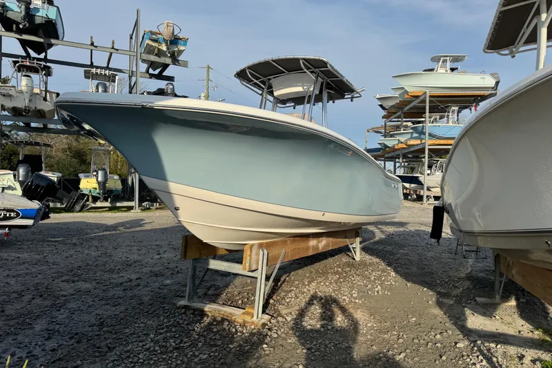 Slide: The Image of 2017 Tidewater 220 CC Adventure boat on display in a marina storage area. - 12