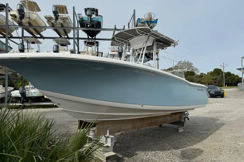 Slide: The Image of 2017 Tidewater 220 CC Adventure boat on display in a marina storage area. - 14