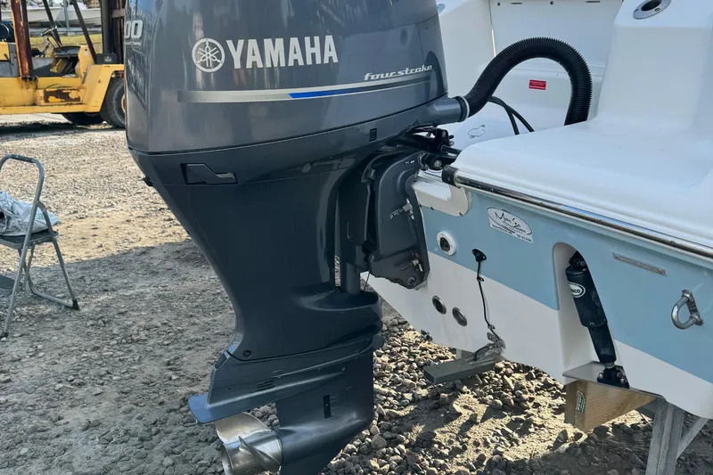 Slide: The Image of 2017 Tidewater 220 CC Adventure with Yamaha outboard motor on gravel surface. - 15