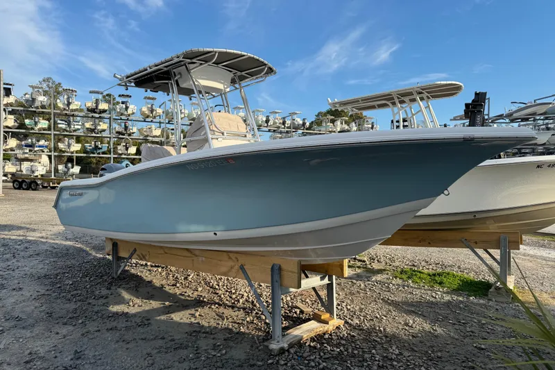 Slide: The Image of 2017 Tidewater 220 CC Adventure boat displayed on a stand, clear blue sky background. - 16
