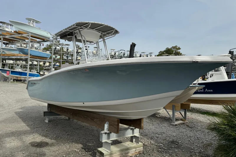 Slide: The Image of 2017 Tidewater 220 CC Adventure boat on display in a marina. - 6