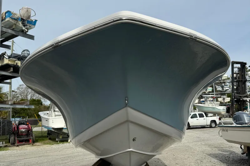 Slide: The Image of 2017 Tidewater 220 CC Adventure boat, front view in a marina setting. - 7