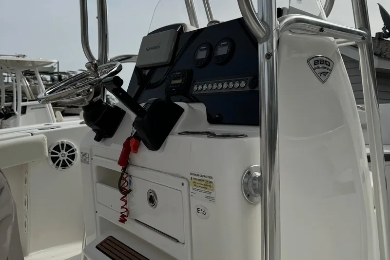 Slide: The Image of 2017 Tidewater 220 CC Adventure boat console with steering wheel and controls. - 9