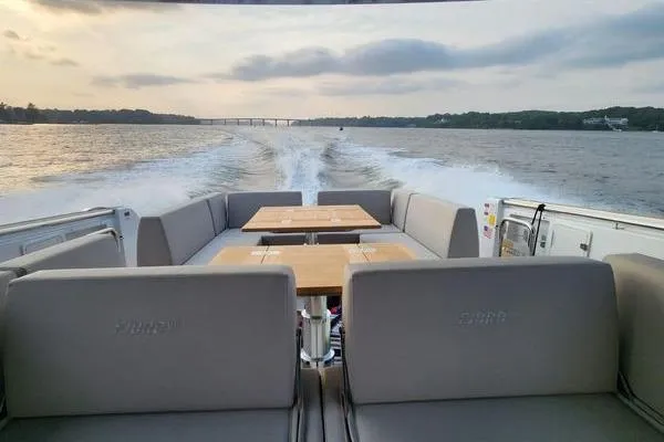Slide: The Image of 2023 Fjord 41 XL luxury yacht cruising on a serene waterway at sunset. - 10