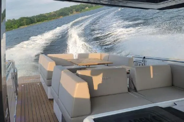 Slide: The Image of 2023 Fjord 41 XL yacht cruising on a scenic waterway, featuring luxurious seating. - 11