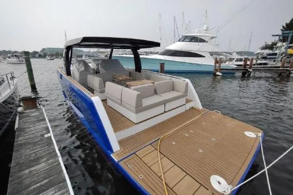 Slide: The Image of 2023 Fjord 41 XL luxury yacht docked, featuring spacious deck and modern design. - 15