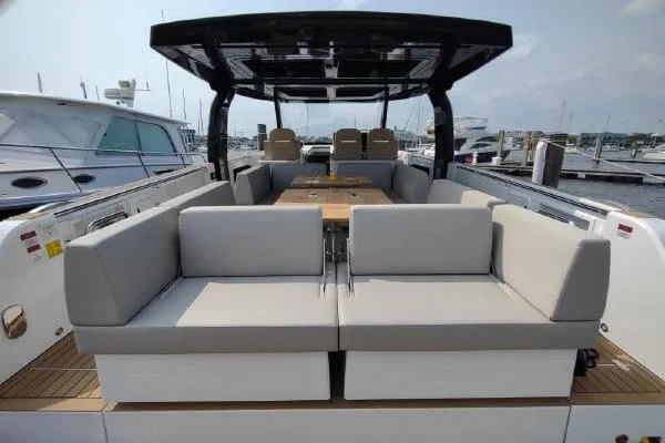 Slide: The Image of Luxurious 2023 Fjord 41 XL yacht with spacious seating and sleek design at a marina. - 17