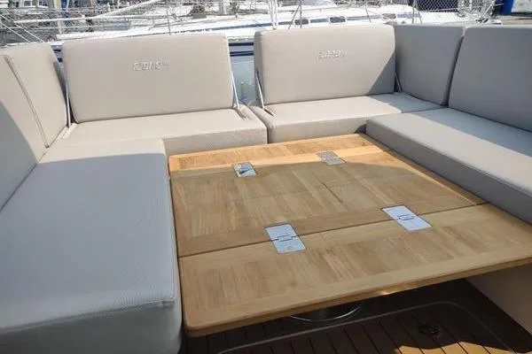 Slide: The Image of 2023 Fjord 41 XL yacht interior with beige seating and wooden table. - 19