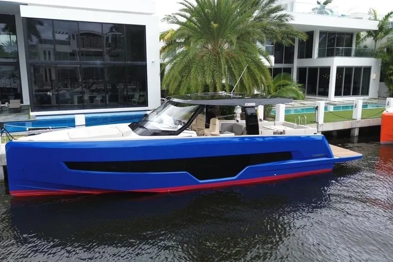 Slide: The Image of 2023 Fjord 41 XL yacht docked by modern waterfront home. - 2