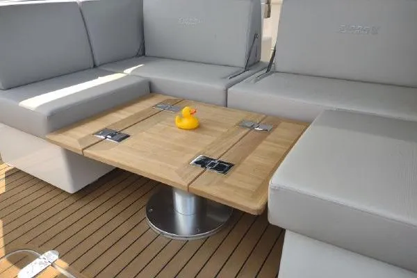 Slide: The Image of 2023 Fjord 41 XL yacht interior with wooden table and rubber duck centerpiece. - 20