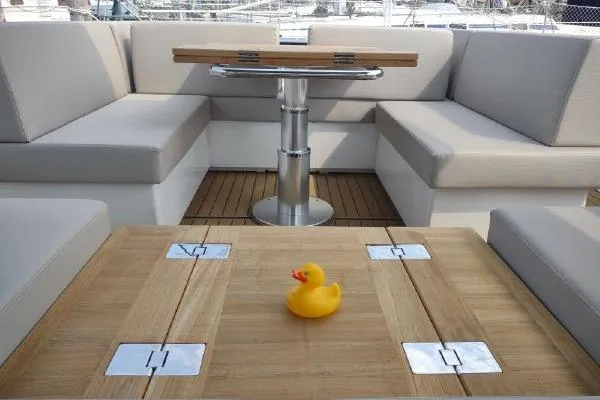 Slide: The Image of 2023 Fjord 41 XL yacht interior with seating, table, and rubber duck centerpiece. - 22