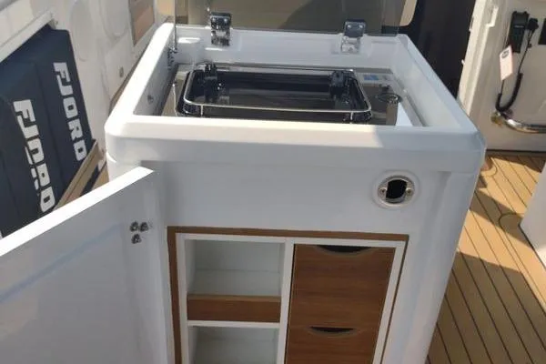 Slide: The Image of 2023 Fjord 41 XL yacht kitchenette with storage and sleek design. - 24