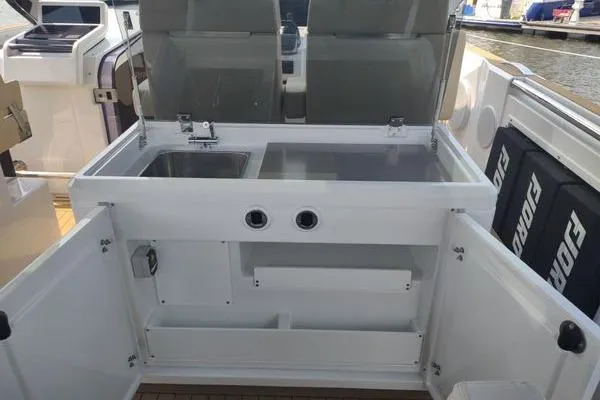 Slide: The Image of 2023 Fjord 41 XL yacht kitchen area with sink and storage compartments. - 26