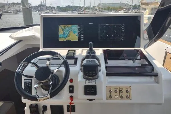 Slide: The Image of 2023 Fjord 41 XL yacht helm with navigation screens and steering wheel. - 27