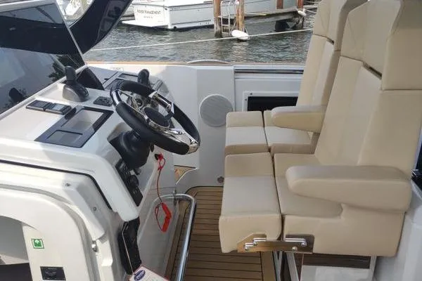 Slide: The Image of 2023 Fjord 41 XL boat cockpit with dual beige captain seats and modern controls. - 28