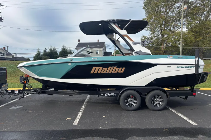 The Image of 2026 Malibu Wakesetter 21 LX boat on trailer, parked outdoors. - 0