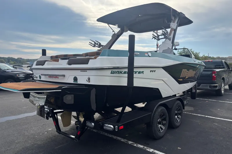 Slide: The Image of 2026 Malibu Wakesetter 21 LX boat on trailer in parking lot. - 10