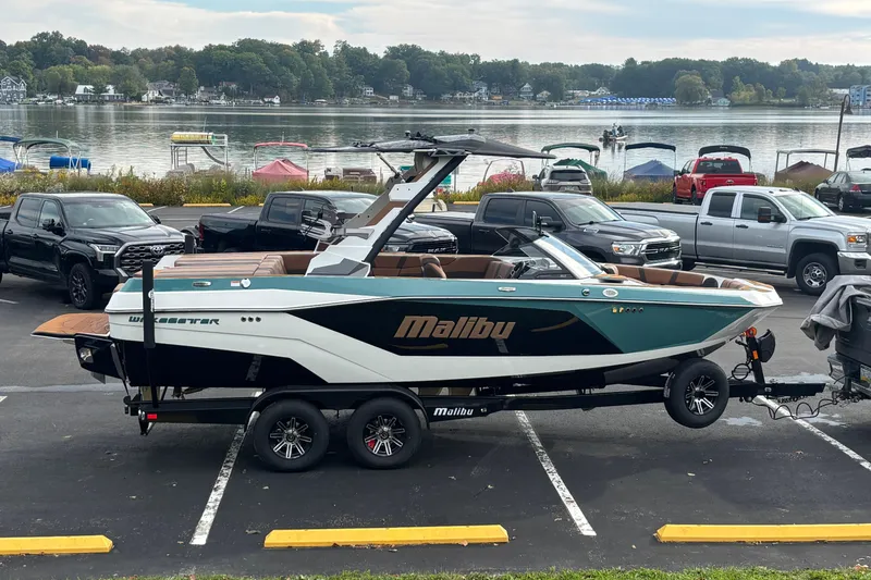 Slide: The Image of 2026 Malibu Wakesetter 21 LX boat on trailer by a scenic lake. - 11