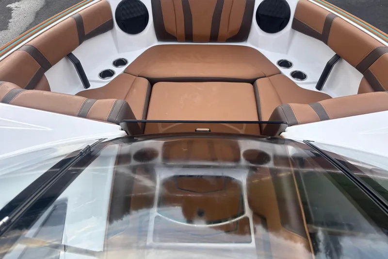Slide: The Image of 2026 Malibu Wakesetter 21 LX boat interior with brown leather seating and cup holders. - 12