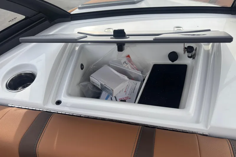Slide: The Image of Open storage compartment in 2026 Malibu Wakesetter 21 LX boat interior. - 15