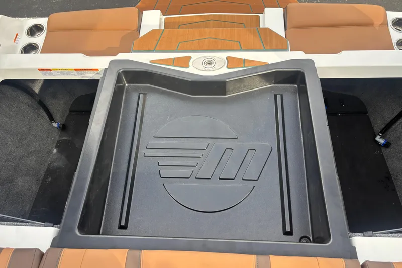 Slide: The Image of 2026 Malibu Wakesetter 21 LX interior with logo, featuring tan seating and cup holders. - 2