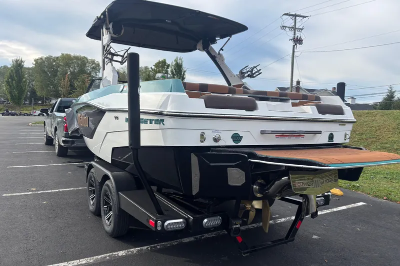 Slide: The Image of 2026 Malibu Wakesetter 21 LX boat on trailer in parking lot. - 9