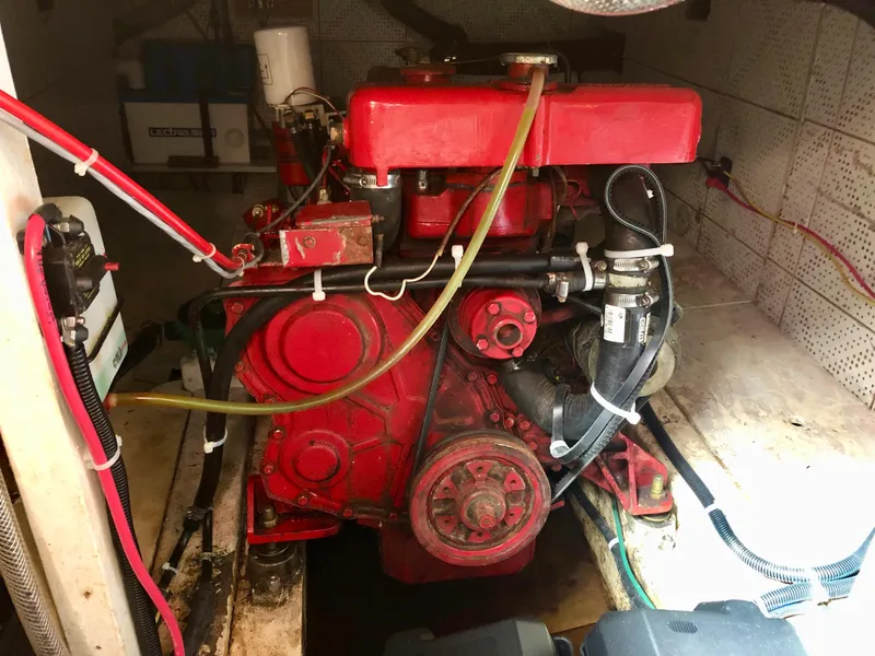 Slide: The Image of 1978 CHB 34 boat helm with laptop, navigation controls, and throttle lever. - 10