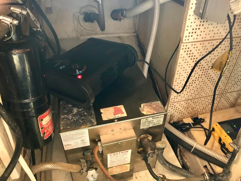 Slide: The Image of 1978 CHB 34 boat kitchen with wooden cabinetry, stove, sink, and refrigerator. - 12