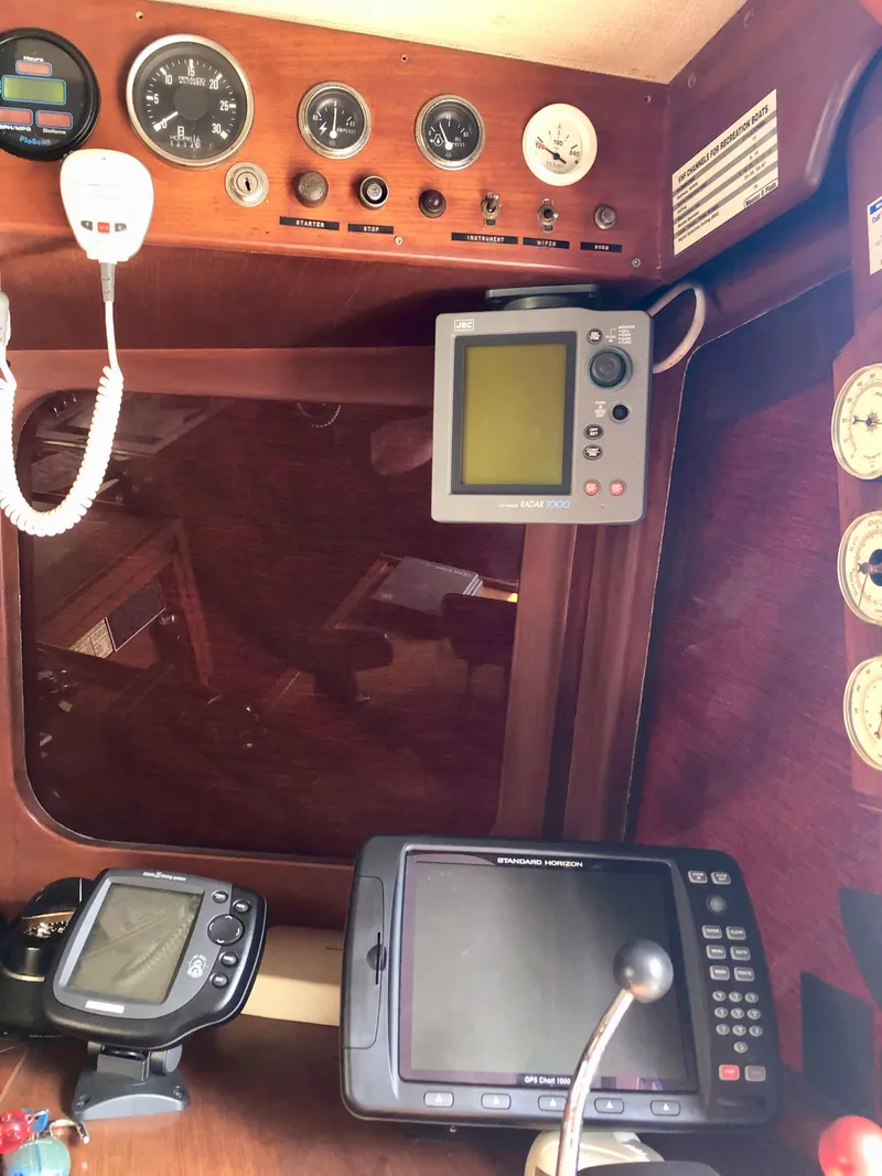 Slide: The Image of 1978 CHB 34 interior with cream leather seating and wooden table. - 13